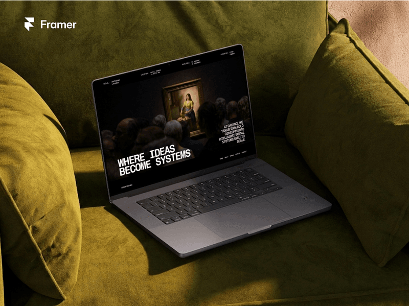 Laptop displaying a Framer website template on a cozy couch setting, featuring bold typography and a creative portfolio layout with the message “Where ideas become systems.
